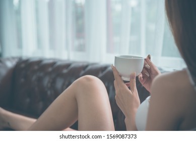 Young  asian woman relaxing on the sofa at home. - Shutterstock ID 1569087373