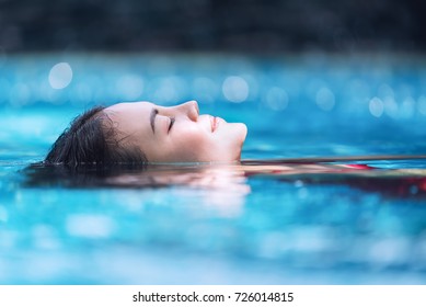 Young Asian Woman Relaxing In Swimming Pool At Spa Resort.relaxing,spa Relax,bikini Concept.