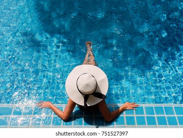 Young asian woman relaxing in swimming pool at spa resort.relaxing concept. - Shutterstock ID 751527397
