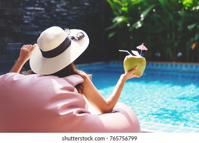 Young Asian Woman Relaxing In Swimming Pool At Spa Resort.relaxing And Spa Relax Concept.