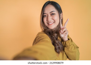 Young Asian Woman Selfie With Peaceful Hand Gesture