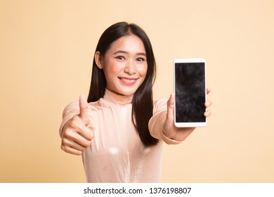 Young Asian Woman Show Thumb Up  With Mobile Phone On  Beige Background