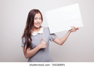 Young Asian Woman Show Thumbs Up With  White Blank Sign On Gray Background