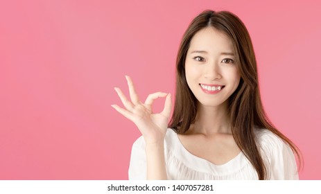 Young Asian Woman Showing A OK Hand Sign.