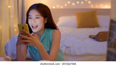young asian woman sitting on floor using smartphone checking social media feeling happy smiling when relax in the room at home - Shutterstock ID 2072667584