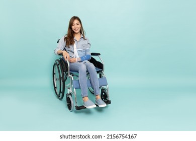 Young Asian woman sitting wheelchair   put soft splint due to broken arm isolated green background  Personal accident concept