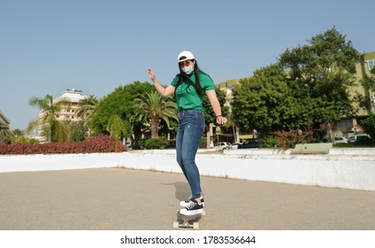 Young asian woman with skateboard and wearing protective face mask - Coronavirus lifestyle - Powered by Shutterstock