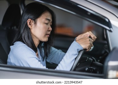 Young Asian Woman Sleepy Tired Close Eyes Driving Her Car After Long Hour Drive. Transportation Sleep Deprivation Accident Concept.