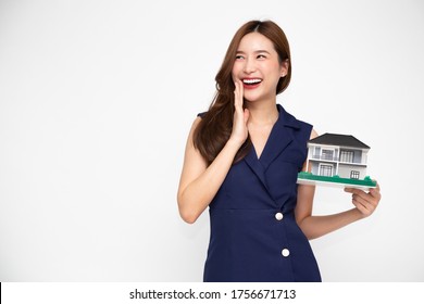 Young Asian woman smiling and holding house sample model isolated over green background, Real estate and home insurance concept - Shutterstock ID 1756671713