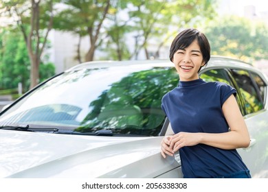 Young Asian Woman Standing Next To The Car.