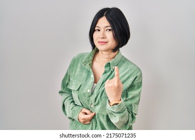 Young Asian Woman Standing Over White Background Beckoning Come Here Gesture With Hand Inviting Welcoming Happy And Smiling 