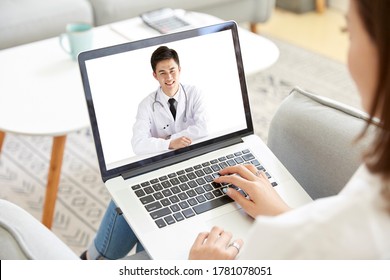 young asian woman staying at home consulting a doctor via video call using laptop computer - Shutterstock ID 1781078051