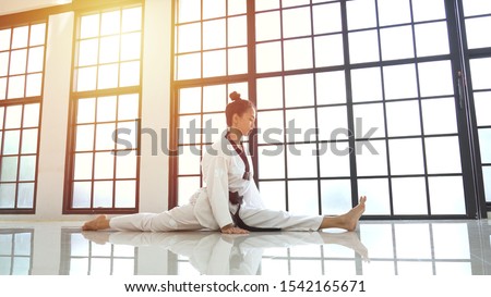 Young asian woman stretches her leg straight during warm up