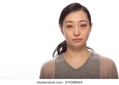Young Asian Woman In Studio Serious Face Portrait