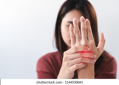 Young Asian Woman Suffering From Pain In Palms. Female Massaging Her Painful Hand From Symptoms Of Peripheral Neuropathy. Pain And Numbness In Fingertips And Palms. Health Care And Physical Concept.