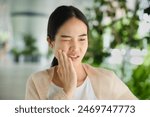 Young Asian woman suffering from toothache, tooth decay, tooth sensitivity, wisdom tooth pain, cavity, dental care concept