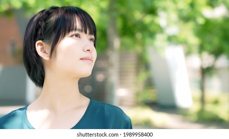 Young Asian Woman In The Sun. Beauty Concept. UV Care.