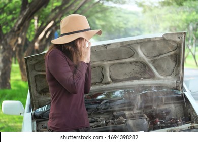 Young Asian Woman Surprise With  Smoke From Engine Of Old Car, It Start Overheat And Break Down . 