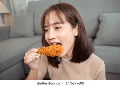 Young Asian Woman Takeaway Eating Junk Food Chicken Nuggets Wing, Female Having Fun Enjoying Fast Food Delivery Service Safe And Stop Coronavirus Spread By Social Distancing Concept.