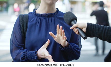 Young asian woman taking interview of TV program.