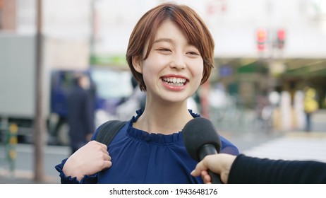 Young asian woman taking interview of TV program.