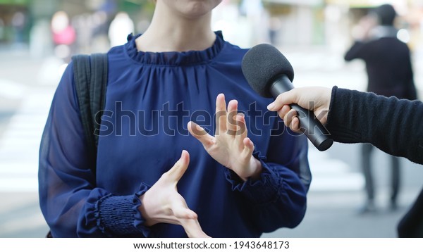 Young asian\
woman taking interview of TV\
program.