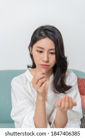 Young Asian Woman Is Taking Medicine In Living Room, Taking Of Necessary Medicines Safer