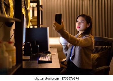 Young Asian Woman Taking Selfie With Coffee While Working From Home Late At Night