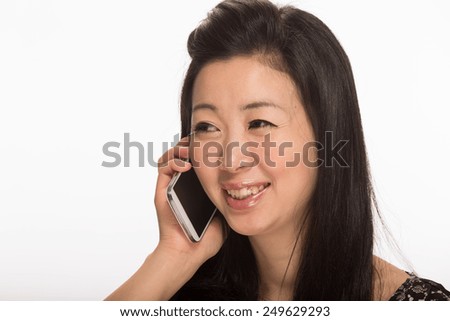 Young Asian woman talking on cell phone smart phone