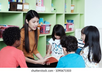 Young Asian Woman Teacher Teaching Kids In Kindergarten Classroom, Preschool Education Concept