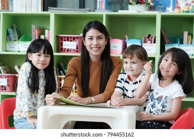 Young Asian Woman Teacher Teaching Kids In Kindergarten Classroom, Preschool Education Concept