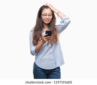 Young Asian Woman Texting Using Smartphone Over Isolated Background Stressed With Hand On Head, Shocked With Shame And Surprise Face, Angry And Frustrated. Fear And Upset For Mistake.