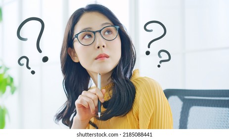 Young Asian woman thinking in the office. - Powered by Shutterstock