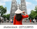 	
Young Asian woman tourist in Ao Dai (traditional Vietnamese dress) sightseeing at St Joseph