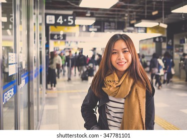 Young Asian woman tourist in Japan Railway station,Osaka.