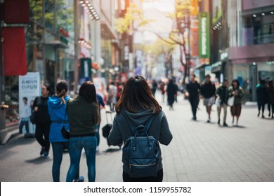 Young Asian Woman Traveler Traveling And Shopping In Myeongdong Street Market At Seoul, South Korea. Myeong Dong District Is The Most Popular Shopping Market At Seoul City.