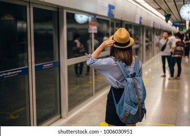 Young Asian Woman Traveler Waiting For Transportation Underground In Bangkok Subway MRT In Thailand