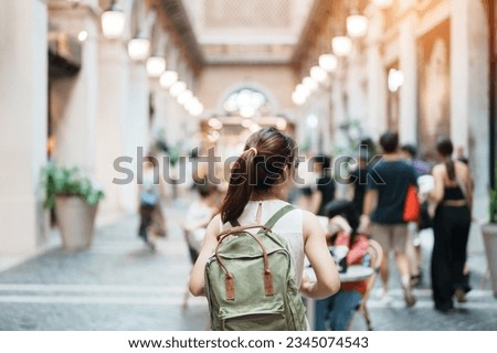 Young asian woman traveler in Yellow dress with bag traveling to NIMMAN on Nimmanhaemin Road, Tourist visit at the Night market city in Chang Mai, Thailand. Asia Travel, Vacation and summer holiday