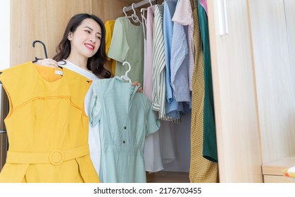 Young Asian Woman Trying On Clothes
