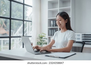Young Asian woman university student satisfied and learning english language during online courses via laptop computer  learning online and webinar  video tutorial  internet lessons