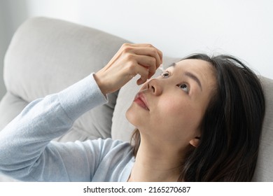 Young Asian Woman Uses Eye Drops For Eye Treatment. Redness, Dry Eyes, Allergy And Eye Itching. Vision And Ophthalmology Medicine Concept.