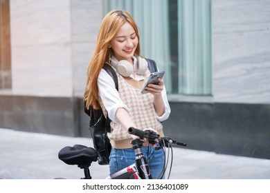 Young Asian woman using bicycle as a means of transportation
