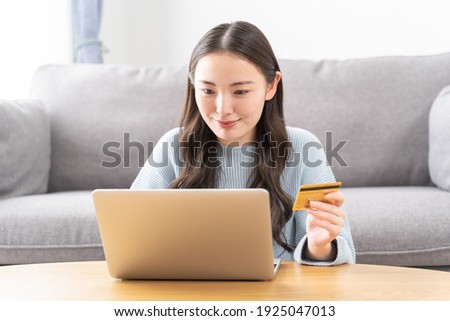 Young Asian woman using a credit card