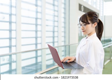 Young Asian Woman Using A Laptop PC. Medical School Student. Science School Student.