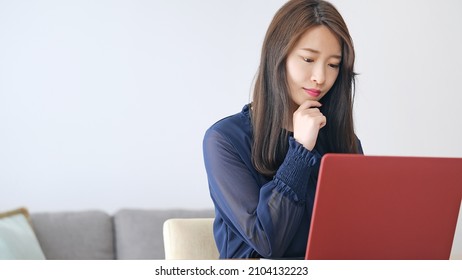 Young Asian Woman Using A Laptop PC.