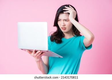 Young Asian Woman Using Laptop On Pink Background