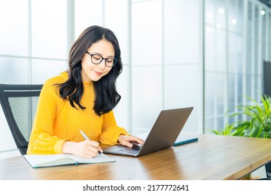 Young Asian woman using a laptop PC in modern office. - Shutterstock ID 2177772641
