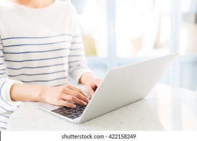 Young Asian Woman Using Laptop Computer In The Cafe