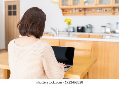 Young Asian Woman Using Laptop,back View