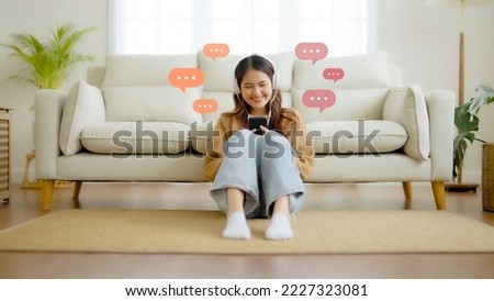 Young asian woman using mobile smartphone in living room. Online live chat chatting on application communication digital media website and social network